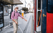 senior-blind-man-with-white-cane-getting-on-public